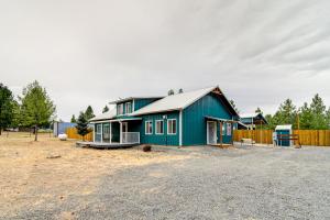 a blue house sitting on top of a dirt lot at Unique Country Farmhouse Near Lake Roosevelt in Fort Spokane