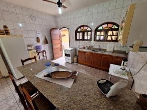 a kitchen with a counter top and a refrigerator at Casa Mega confortável a pé da Praia Pereque Angra in Angra dos Reis +23 photos
