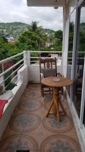 a table and chairs on a balcony with a view at Zihua 360 in Zihuatanejo