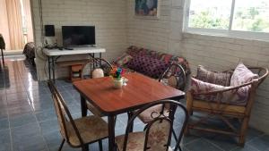 a living room with a table and a couch at Zihua 360 in Zihuatanejo