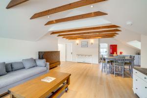 a living room with a couch and a table at Victorian Carpinteria Apartment Less Than 1 Mi to Beach! in Carpinteria