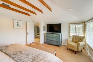 a bedroom with a bed and a chair and a television at Victorian Carpinteria Apartment Less Than 1 Mi to Beach! in Carpinteria