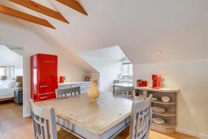 a dining room with a table and a red refrigerator at Victorian Carpinteria Apartment Less Than 1 Mi to Beach! in Carpinteria