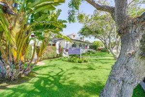 a house with a green yard with a tree at Victorian Carpinteria Apartment Less Than 1 Mi to Beach! in Carpinteria