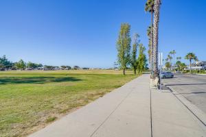 a sidewalk next to a park with a palm tree at Victorian Carpinteria Apartment Less Than 1 Mi to Beach! in Carpinteria