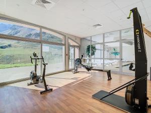 a gym with treadmills and exercise bikes in a room at Appartement 2 chambres en duplex à La Mongie in La Mongie