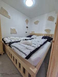 a large wooden bed in a room with at Murter Palms Resort Apartments in Murter +122 photos