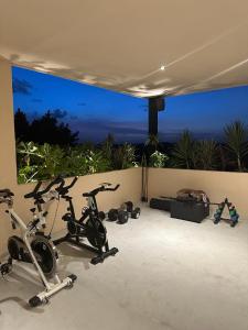 a room with three exercise bikes in front of a window at La Veleta luxury condos in Tulum