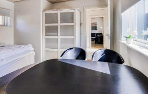 a black table and chairs in a room with a bed at Stunning Apartment In Skagen With Wifi in Skagen