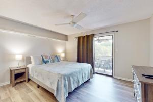 a bedroom with a bed and a balcony at SEA STAR in Cape Canaveral