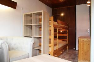 a room with a bunk bed and a couch at Résidence Makalu - Studio divisible 4 personnes Plagne Centre MAE-3484 in Aime La Plagne