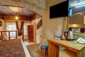 a living room with a tv on the wall at Avilla Cave Hotel in Göreme
