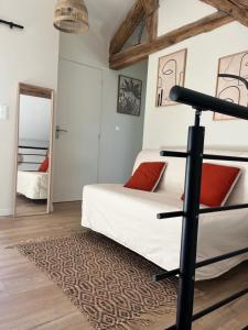 a bedroom with a bed and a mirror at Maison au bord de la Loire in Saint-Jean-le-Blanc