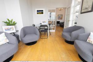 a living room with two chairs and a table at Port Lush in Portrush