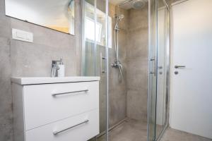 a bathroom with a sink and a shower at Sunset Holiday3 in Njivice