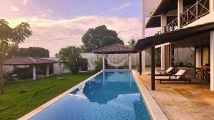 a swimming pool in the yard of a house at Casa Dois Mares in Pipa