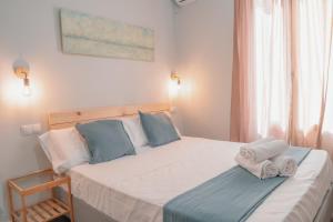 a bedroom with a bed with towels on it at CH Barco in Madrid