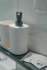 a shelf with a hair dryer and a bottle on it at CH Barco in Madrid
