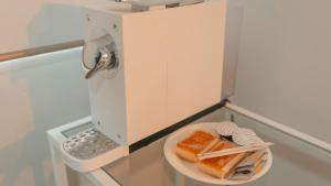 a microwave with a plate of food on a counter at CH Barco in Madrid +28 photos