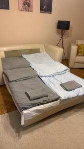 a bed with two pillows on it in a room at Relax apartman in Siófok