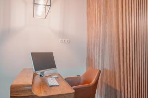 a wooden desk with a computer and a chair at CH Barco in Madrid