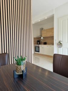 a dining room table with a potted plant on it at Ferienwohnung Selo A in Coppenbrügge +7 photos