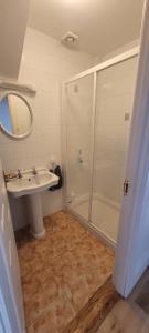 a bathroom with a sink and a shower at Port Lush in Portrush +24 photos