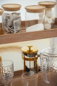 a shelf with glass jars and other items on it at Glamping Meadow Bell Tent in Stithians
