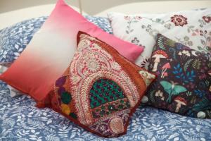 a pile of pillows sitting on top of a bed at Glamping Meadow Bell Tent in Stithians