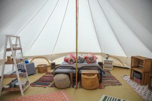 a bedroom in a sail boat with a bed at Glamping Meadow Bell Tent in Stithians