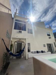 een wit huis met een hangmat ervoor bij Casa com piscina, churrasqueira e terraço com vista pro mar! in Mangaratiba