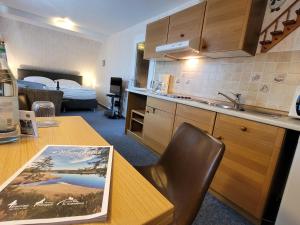 a kitchen with a table and a room with a bed at Villa Gesine in Braunlage