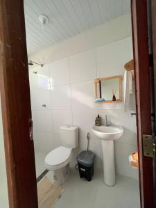 a bathroom with a toilet and a sink at Temporada BHS Quarto 3 in Barreirinhas