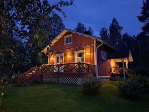 a large house with a large deck at night at tunnelmallinen vapaaajanpaikka in Toiviaiskylä