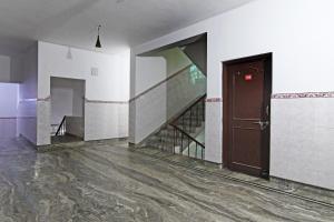 an empty room with a staircase and a door at Hotel O Home Elite Stay Near Shri Shri Shiridi Sai Mandir in Bhubaneshwar