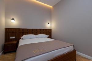 Postel nebo postele na pokoji v ubytování Hotel Vila 101-New Bazaar