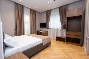 Postel nebo postele na pokoji v ubytování Hotel Vila 101-New Bazaar