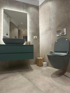 a bathroom with a sink and a toilet and a mirror at Yacht Concept Durrës Marina in Durrës +15 photos