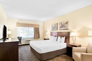 a hotel room with a bed and a television at Best Western Nebraska City Inn in Nebraska City