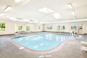 a large swimming pool in a large room with windows at Best Western Nebraska City Inn in Nebraska City