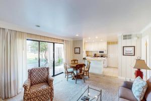 a living room with a table and chairs and a kitchen at Silverado Resort and Spa 271 & 272 in Napa