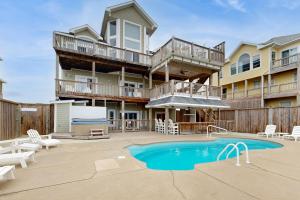 a large apartment building with a pool and patio at Ocean Rush #2-HH in Hatteras