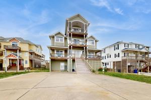 a row of houses with a driveway in front at Ocean Rush #2-HH in Hatteras
