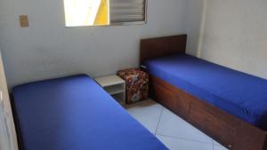 a small bedroom with two beds and a window at Yellowkits in Sao Paulo