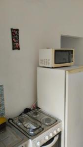 a microwave sitting on top of a refrigerator at Yellowkits in Sao Paulo +20 photos