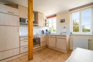 a kitchen with a sink and a stove top oven at Ferienwohnung-Mueritzkoje-an-der-Mueritz in Vipperow