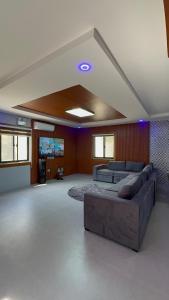 a large living room with a couch and a tv at Luxury Pool 4mins WALKING STREET AND Friendship Highway in Angeles