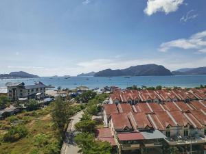 an aerial view of a town with houses and the ocean at Langkawi Simfoni Cassia Suite 04 9pax in Kuah
