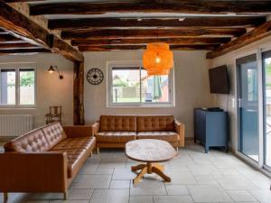 a living room with a couch and a table at Maison familiale avec piscine chauffée, salle de jeux et grand jardin - 5 chambres, 15 couchages - FR-1-410-340 in Changé