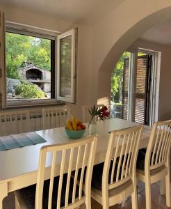 a kitchen with a table with a bowl of fruit on it at Holiday house with a swimming pool Grubine, Zagora - 22263 in Krivodol